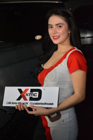 Photo for "Female model at bumper to bumper car show in Philippines" - Royalty Free Image