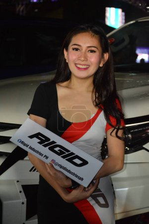 Foto de "Female model at bumper to bumper car show in Philippines" - Imagen libre de derechos