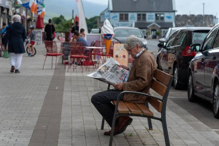 Photo for Man Reading Newspaper on the street - Royalty Free Image