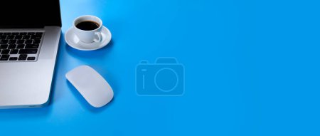 Photo for Laptop, mouse coffee on blue background. Laptop, mobile phone - Royalty Free Image