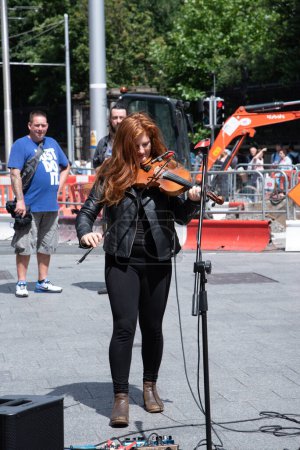 Téléchargez les photos : Musiciens de rue pendant le spectacle de jour dans la rue - en image libre de droit