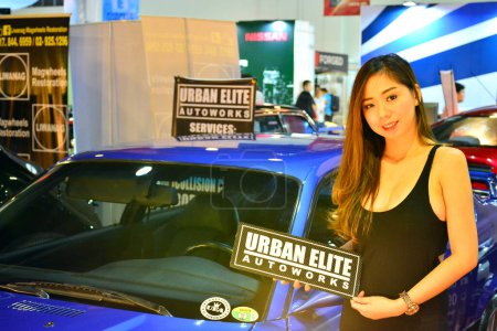 Photo for "Urban Elite autoworks female model at Trans Sport Show in Pasay - Royalty Free Image