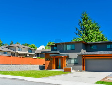 Photo for Residential house with wide garage door and concrete driveway - Royalty Free Image