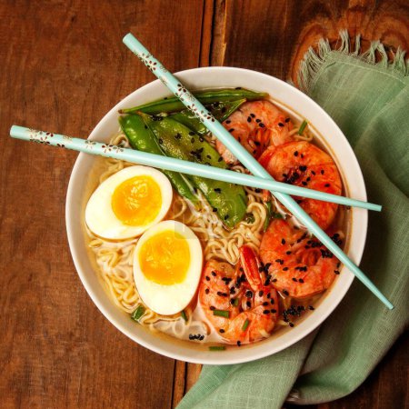 Photo for "ramen with egg and prawns with blue chopsticks" - Royalty Free Image