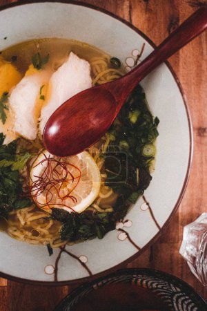 Photo for "fish ramen soup with lemon and wooden spoon" - Royalty Free Image
