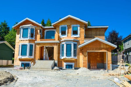 Photo for Brand new residential house under construction on blue sky background - Royalty Free Image