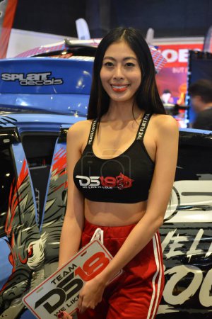 Photo for "Team DS18 female model at Bumper to Bumper prime car show in Pasay - Royalty Free Image
