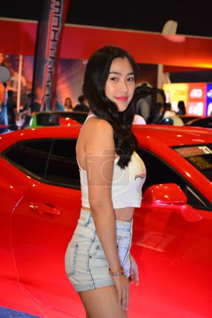 Photo for "Frontrow female model at Bumper to Bumper prime car show in Pasay - Royalty Free Image