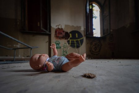 Photo for A vintage doll abandoned in the rooms of an abandoned psychiatric hospital - Royalty Free Image
