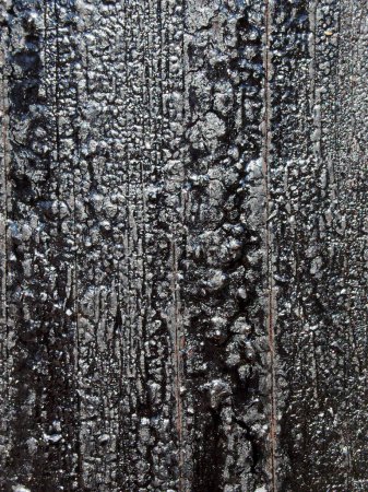 Photo for Black melting old bitumen preservative covered textured wooden surface - Royalty Free Image