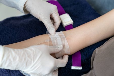 Photo for Doctor hand put intravenous(IV) injection on patient arm - Royalty Free Image