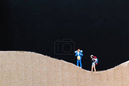 Photo for Miniature people :  Traveler with backpack walking on The paper - Royalty Free Image