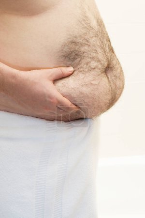 Photo for Barechested man with hands on belly mid section - Royalty Free Image