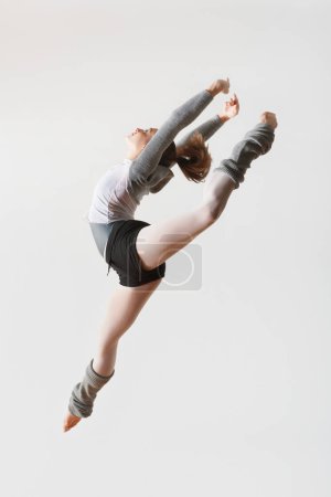 Photo for Ballerina Leaping in Mid-air - Royalty Free Image