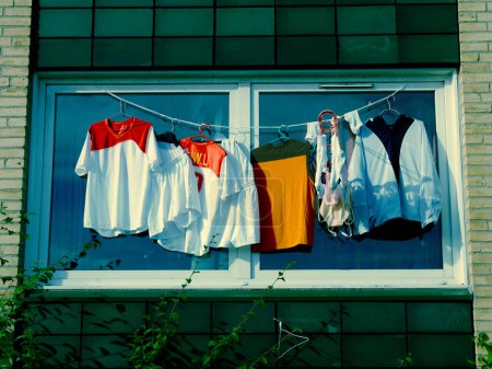 Téléchargez les photos : Chemises séchant sur corde à linge fenêtre extérieure - en image libre de droit