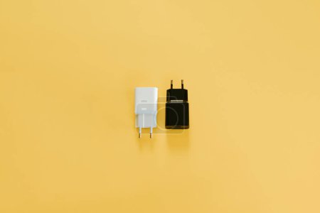 Photo for A white and a white charger over a yellow table - Royalty Free Image