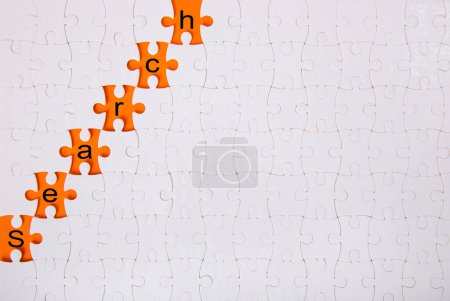 Photo for Jigsaw puzzle with word search on orange background - Royalty Free Image