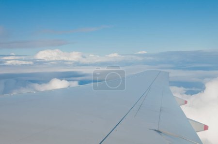Photo for Wing of jumbo jet aircraft plane fly in the blue sky - Royalty Free Image