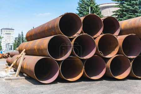 Photo for Large, old and rusty sewer pipes stacked in one batch for recycling - Royalty Free Image