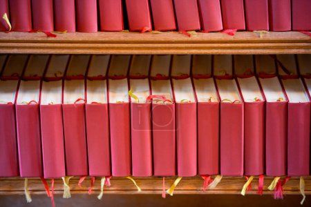 Photo for Stack of red bible books in church. Sweden, Europe - Royalty Free Image