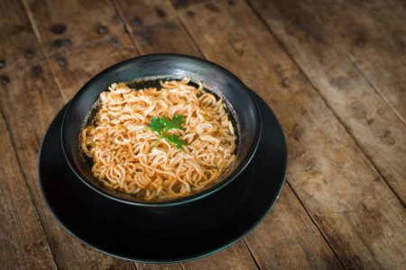 Photo for "Instant noodles in a cup on the wooden floor" - Royalty Free Image