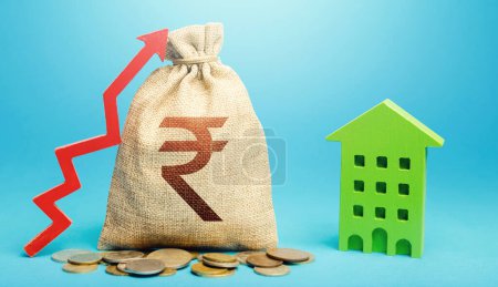 Photo for Indian rupee money bag with red up arrow and residential building. Return on investment. Recovery and growth in property cost. Increase in prices for apartments and housing. Municipal budget. - Royalty Free Image