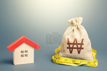 Photo for House and south korean won money bag. Mortgage loan. Buying and selling, fair price. Building maintenance. Calculation of expenses for purchase, construction and repair. Property real estate valuation - Royalty Free Image