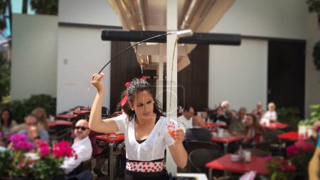 Photo for Waitress serving and pouring Sherry, a traditional habit called Venenciar in Malaga, Spain - Royalty Free Image