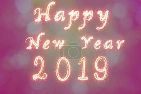 Photo for "Happy new year 2019 written with Sparkle firework on fireworks w" - Royalty Free Image
