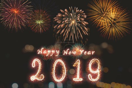 Photo for "Happy new year 2019 written with Sparkle firework on fireworks w" - Royalty Free Image
