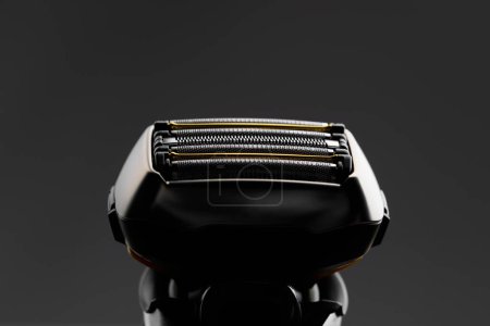 Photo for Electric razor foil shaver mesh and blades, close-up view, dark background - Royalty Free Image