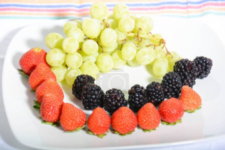 Photo for Fresh fruit on a plate on a table - Royalty Free Image
