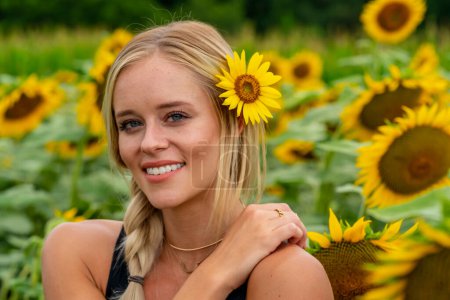 Photo for "A Lovely Blonde Model Poses In A Gorgeous Sunflower Field While Enjoying A Summers Day" - Royalty Free Image