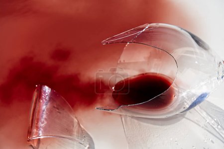 Photo for Broken wine glass with red wine. Glass of wine, broken on the mirror. Isolated on white. - Royalty Free Image