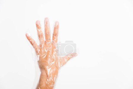 Foto de La mano de mujer que usa un solo uso protege el plástico transparente desechable - Imagen libre de derechos