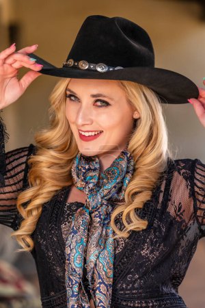 Photo for A Lovely Blonde Model Dressed As A Cowgirl Enjoys The American West - Royalty Free Image