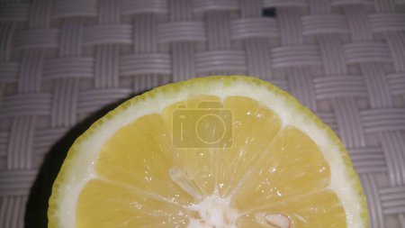 Photo for Fresh lemon slices with yellow peelings placed on a grey floor - Royalty Free Image