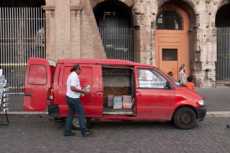 Photo for Rome, Italy - June 27, 2010: A man keep stuff in a van - Royalty Free Image