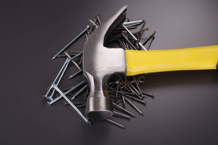 Photo for Hammer and nails on black background - Royalty Free Image