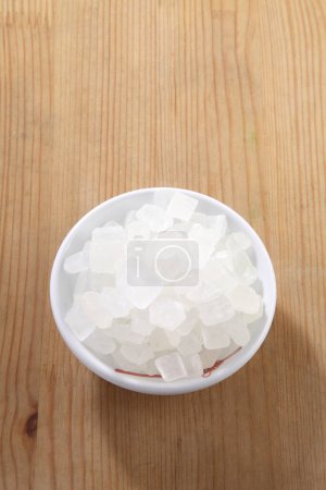 Photo for Rock sugar in bowl on wooden background - Royalty Free Image