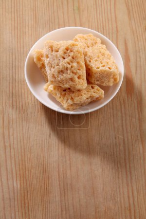 Photo for Brown rock sugar in bowl on wooden background - Royalty Free Image