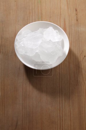 Photo for Rock sugar in bowl on wooden background - Royalty Free Image
