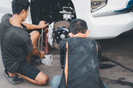 Téléchargez les photos : Vérification du système de freinage de voiture pour réparation au garage de la voiture - en image libre de droit