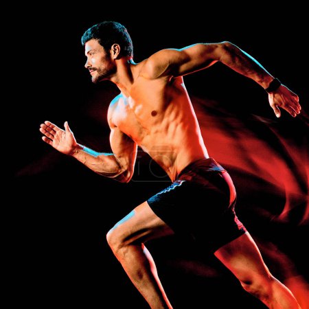 Foto de Hombre musculoso en topless corredor. running jogger jogging aislado negro fondo - Imagen libre de derechos