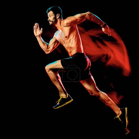 Foto de Hombre musculoso en topless corredor. running jogger jogging aislado negro fondo - Imagen libre de derechos