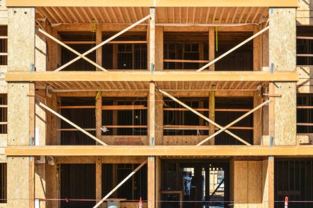 Photo for Wooden framework of brand new low-rise building on sunny day. - Royalty Free Image