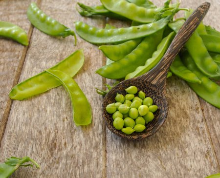 Photo for Fresh green peas on wooden background - Royalty Free Image