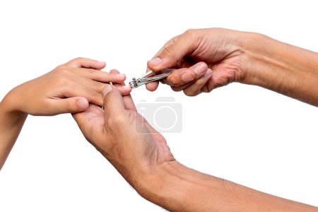 Photo for Father helping his kid to cut fingernails - Royalty Free Image