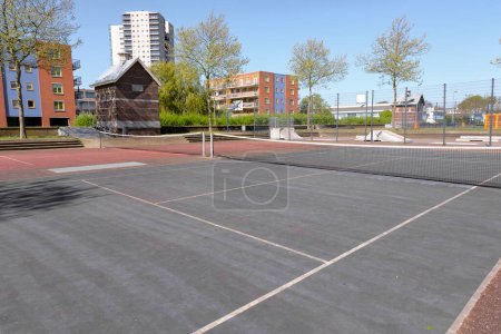Photo for Public tennis courts with green and red marking with no players - Royalty Free Image