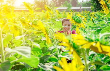 Photo for Woman posing in field of Beautiful sunflowers - Royalty Free Image